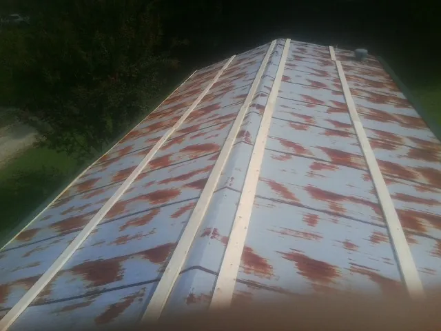 Rusted metal roof panels with new wood purlins before replacement — Storm Damage Roof Repair in Knippa by Roofing Brothers